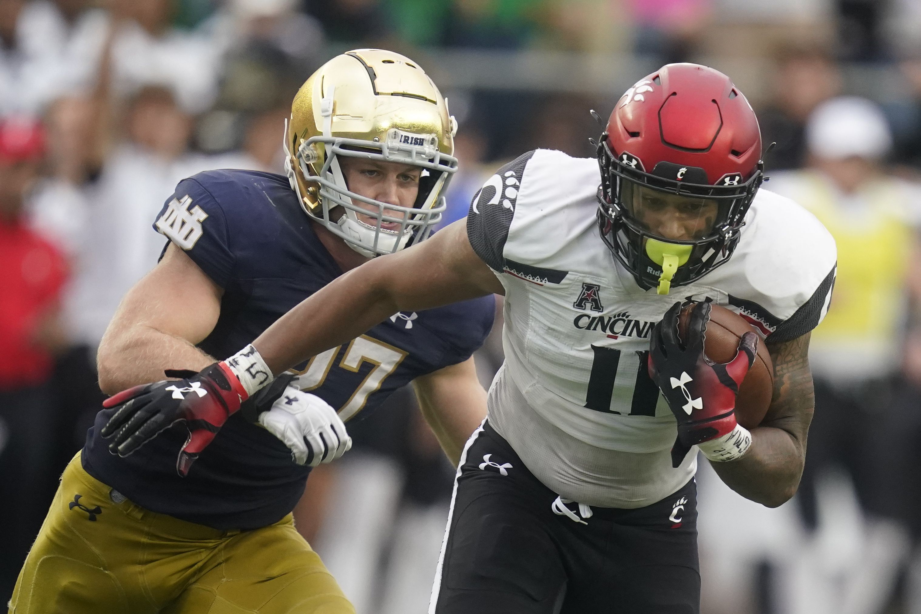 Desmond Ridder shines as No. 7/8 Cincinnati defeats No. 9/7 Notre Dame  24-13 in South Bend