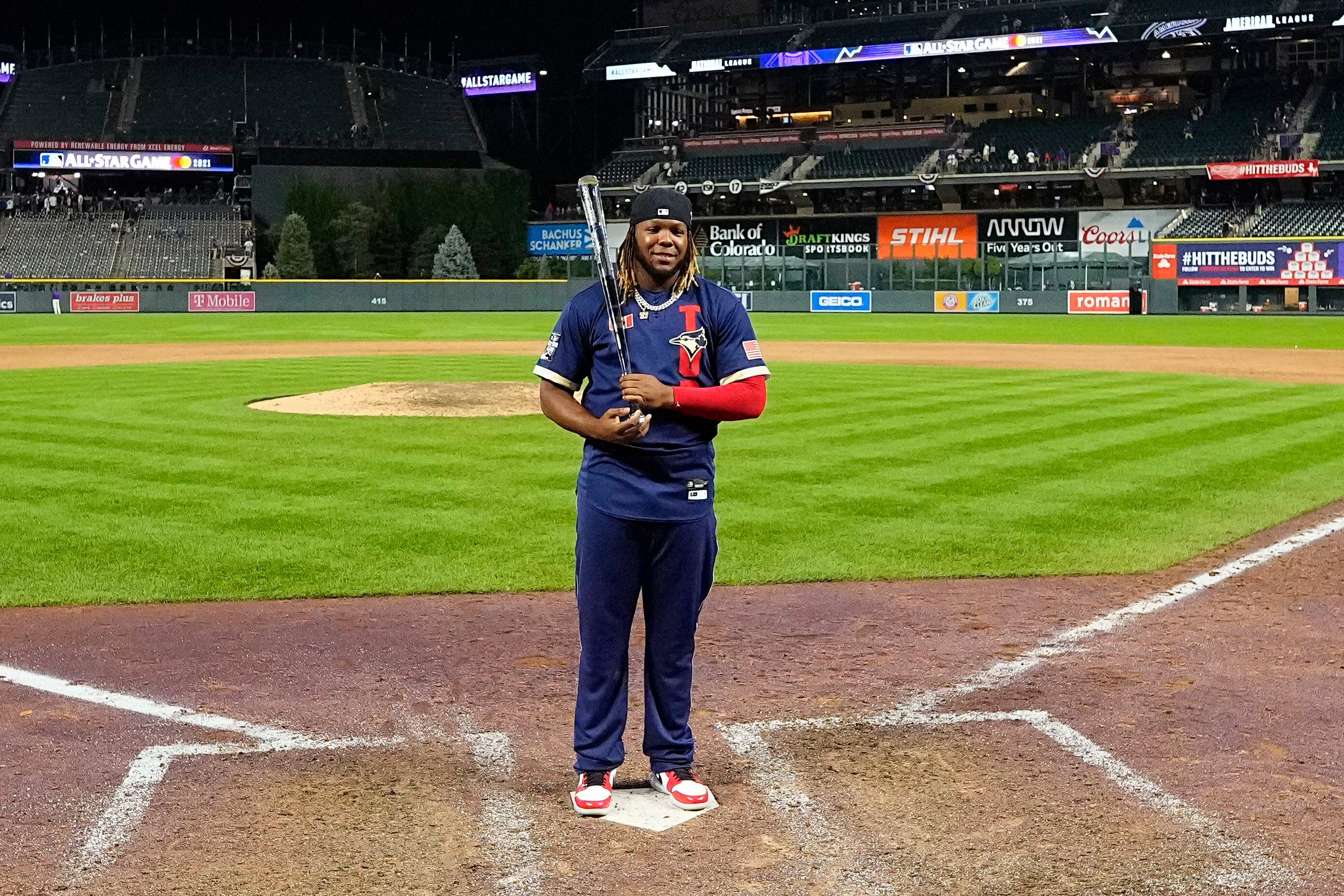 Denver, Colorado. July 13, 2021, The American League's Vladimir Guerrero Jr.,  of the Toronto Blue Jays, celebrates with the MVP trophy after the MLB All- Star baseball game on July 13, 2021, at