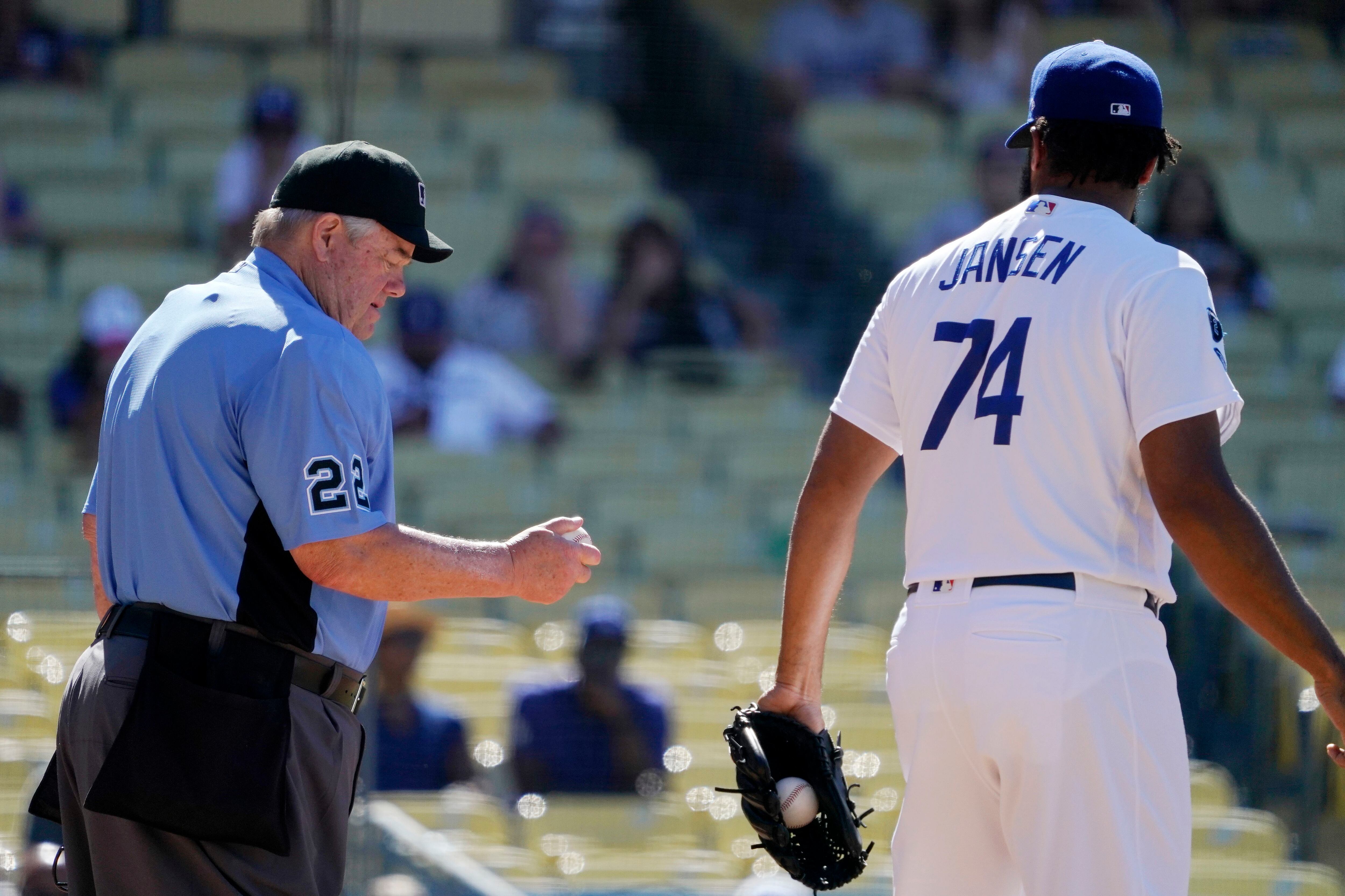 Los Angeles Dodgers reliever Kenley Jansen carries his daughter