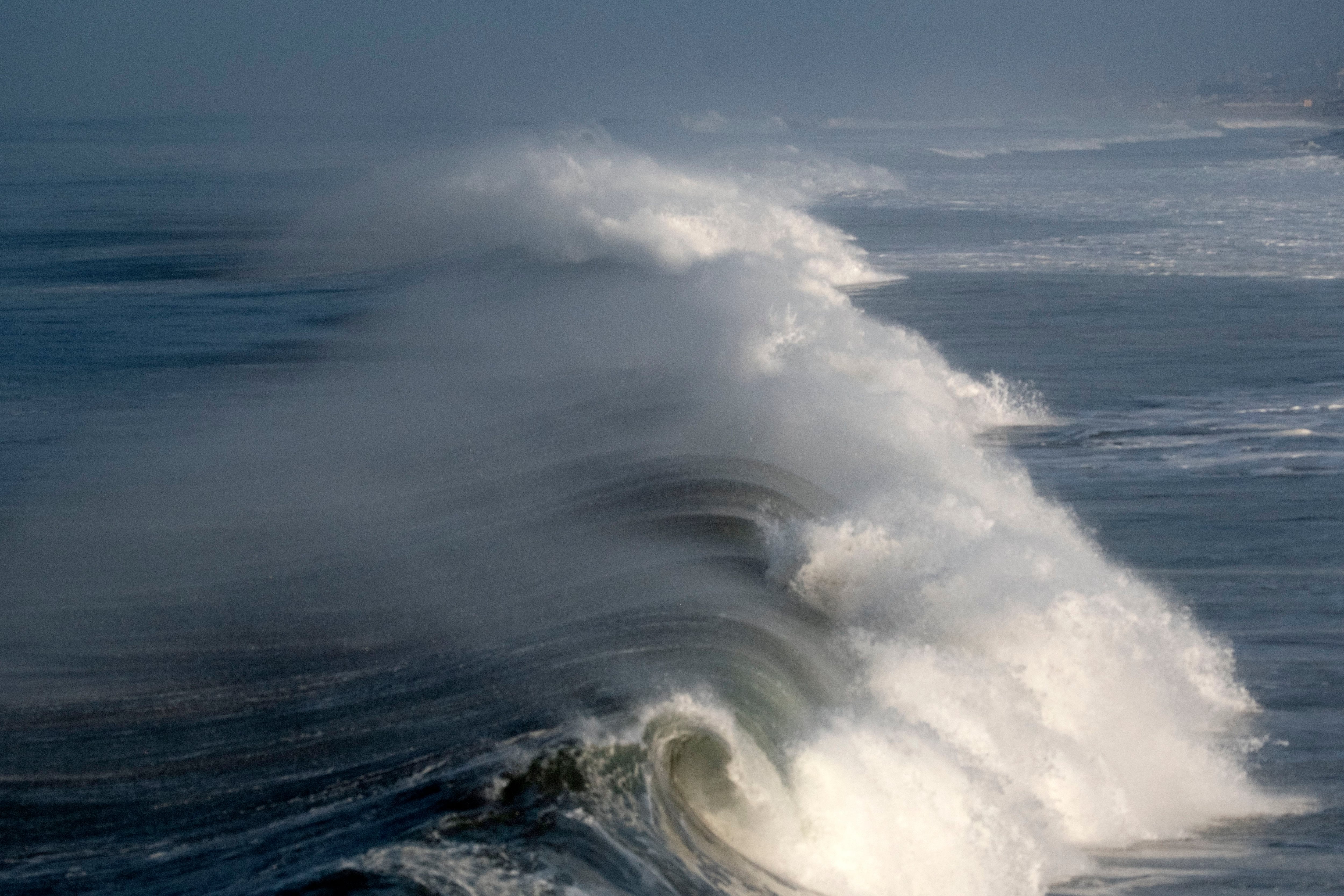 Huge surf pounds West Coast and Hawaii, flooding some low-lying areas