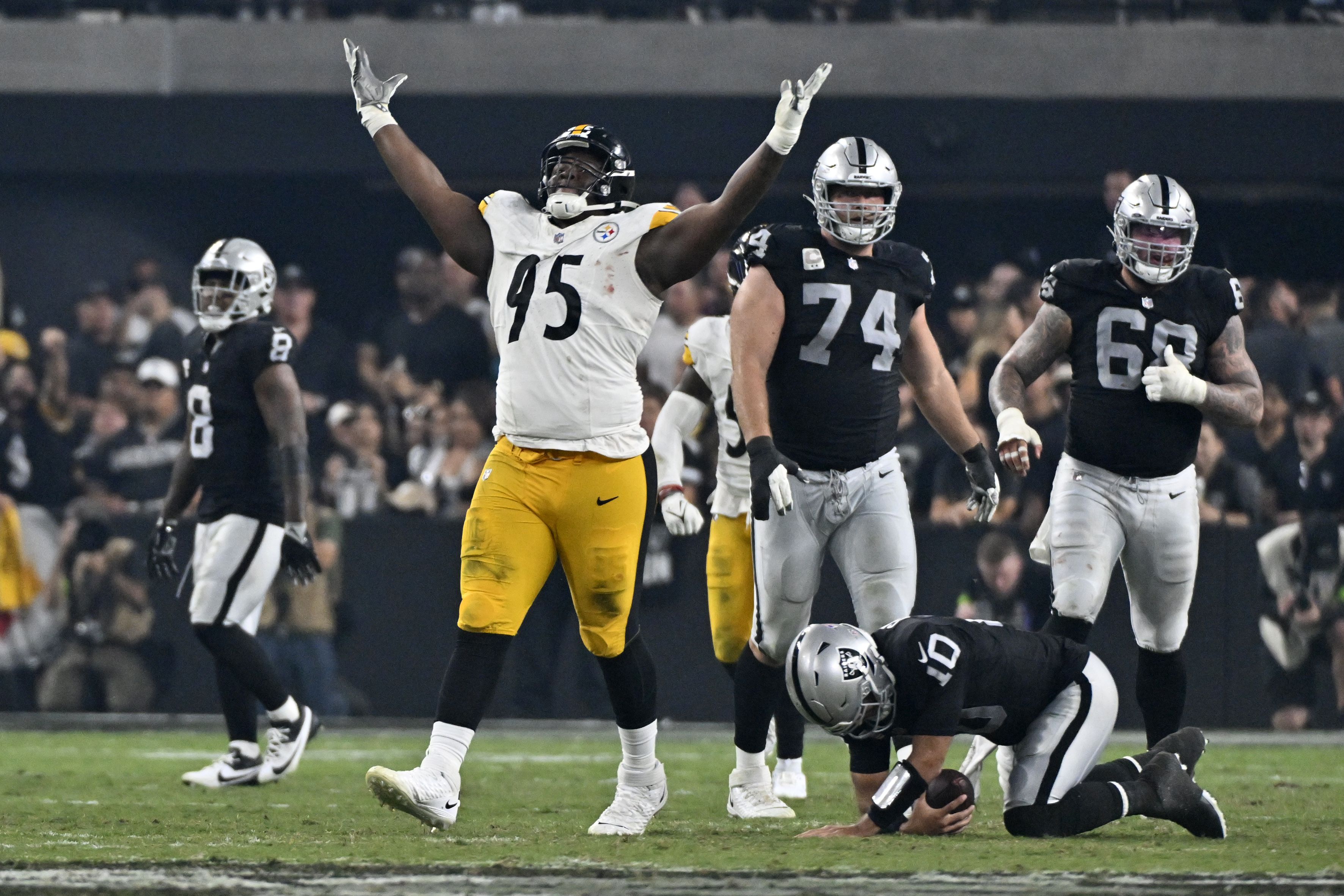 Las Vegas Raiders quarterback Jimmy Garoppolo, center, is sacked by  Pittsburgh Steelers linebacker T.J. Watt, right, as defensive end DeMarvin  Leal runs in during an NFL football game Sunday, Sept. 24, 2023