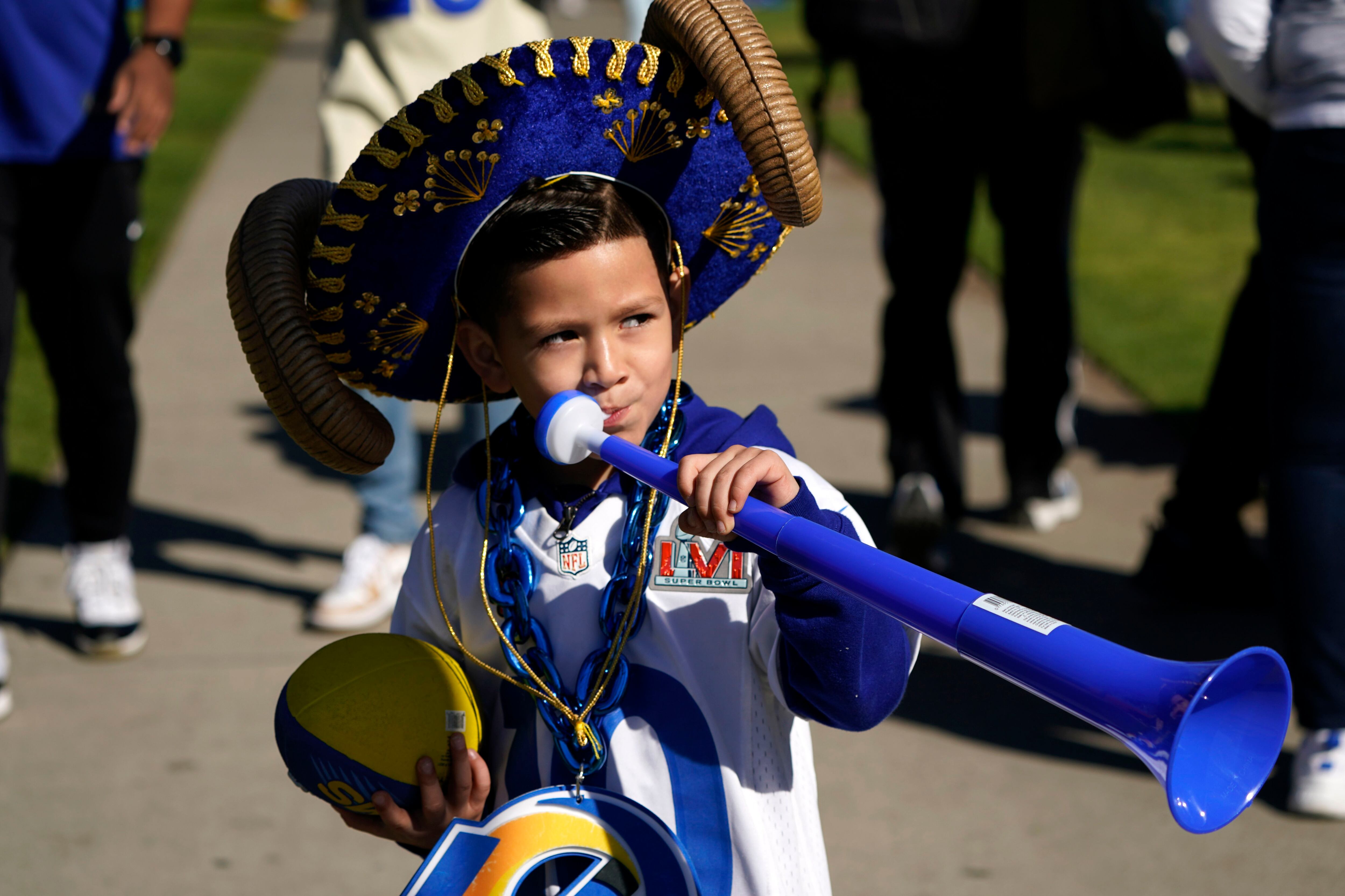 Buses carrying Los Angeles Rams players and coaches drive past fans during  the team's victory parade in Los Angeles, Wednesday, Feb. 16, 2022,  following their win Sunday over the Cincinnati Bengals in